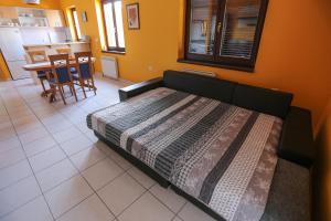 a bed in a room with a kitchen and a table at Apartment Sunny Place in Pula