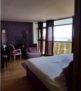 a hotel room with a bed and a large window at LxRiverside Suite Apartment in Lisbon