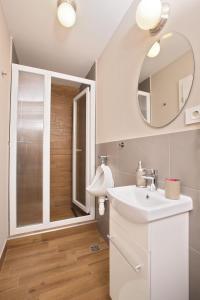 a bathroom with a sink and a mirror at Boutique Apartments Oradea in Oradea