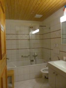 a bathroom with a tub and a toilet and a sink at BnB Goldberg in Schmerikon
