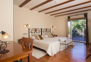 a bedroom with a bed and a table and a desk at Hotel Tossal d'Altea in Altea +37 photos