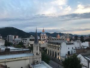 a view of a city with buildings and a church at Departamentos Belgrano in Salta