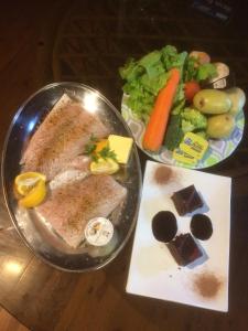 a table with a plate of food and a salad at The Mouses House Rainforest Retreat in Springbrook