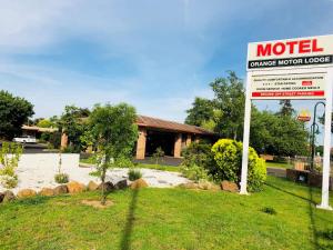 a motel sign in front of a house at Orange Motor Lodge in Orange