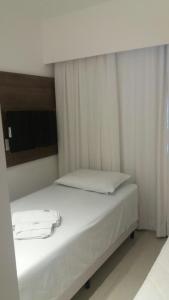A bed or beds in a room at Flat Recife Hotel & Convention