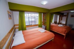Postel nebo postele na pokoji v ubytování Ukukus Hostel