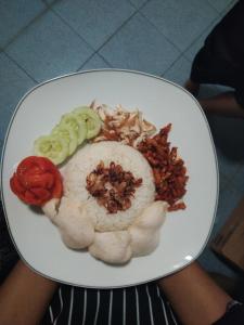 a plate of food with vegetables on it at Ndalem Diajeng in Yogyakarta +9 photos