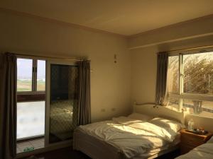 a bedroom with a bed and a large window at manor in Houli