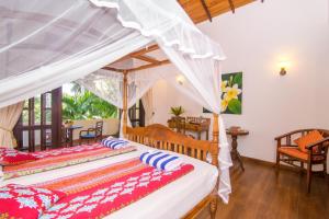 Ένα ή περισσότερα κρεβάτια σε δωμάτιο στο Lanka Beach Bungalows