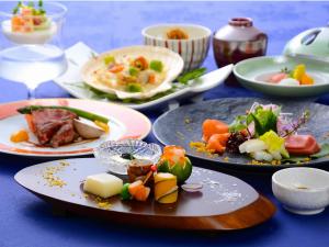 una mesa azul con platos de comida. en Yugashima Golf Club & Hotel Resort, en Izu