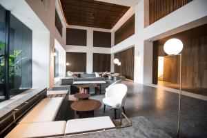 a lobby of a hotel with tables and chairs at KL Sentral Bangsar Suites (EST) by Luxury Suites Asia in Kuala Lumpur