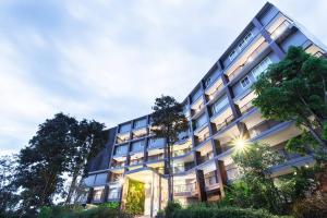 a large building with trees in front of it at Urban Maerim in Mae Rim