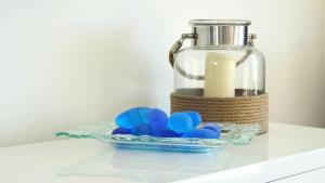 a glass bowl of blue balls next to a glass jar at Millpond. in Penneshaw