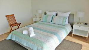 a bedroom with a bed with two towels on it at Millpond. in Penneshaw
