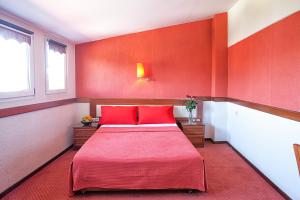A bed or beds in a room at Anastassiou Hotel - Bike and motorcycle friendly hotel