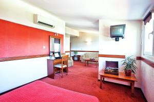 A television and/or entertainment centre at Anastassiou Hotel - Bike and motorcycle friendly hotel