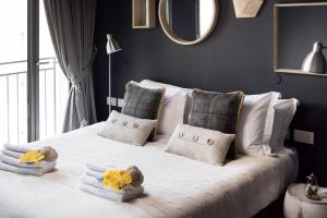 a bedroom with a white bed with towels and pillows at Sweet Inn - Mamilla Boulevard in Jerusalem