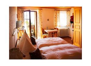 - une chambre avec un lit, une table et un bureau dans l'établissement Pension Draxlerhof, à Neuschönau