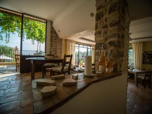 a living room with a table and a large window at Auberge De Tourrettes in Tourrettes-sur-Loup