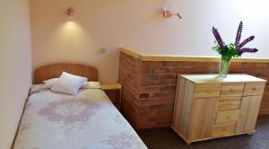 En eller flere senge i et værelse på Apartamenty Pod Jesionem