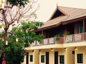 a building with a balcony on top of it at Sri Siam Resort in Kanchanaburi City