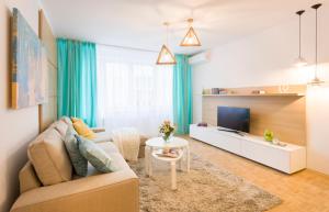 布加勒斯特豪华住宿公寓　的客厅里有一张沙发和一台电视