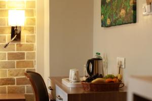 a kitchen with a table with a basket of fruit on it at Hotel Arts Kathmandu in Kathmandu