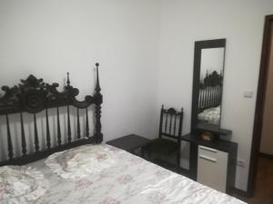 a bedroom with a bed and a mirror at Santo Tirso Holidays Home in Santo Tirso