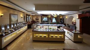 a restaurant with a buffet of food on display at Carlton Palace Hotel in Dubai