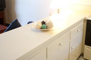 a white counter with a bowl of easter eggs on it at Coral Reef Inn & Condo Suites in Alameda