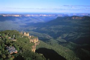 a view of the blue mountains with houses on the cliff at Lilianfels Blue Mountains Resort & Spa in Katoomba