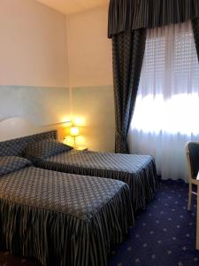 Postel nebo postele na pokoji v ubytování Hotel Internazionale Gorizia
