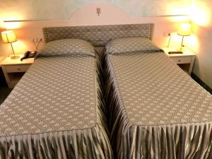 Postel nebo postele na pokoji v ubytování Hotel Internazionale Gorizia