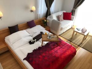 a living room with a couch and a coffee table at Viktoria Lodge Bed and Breakfast in Vodice