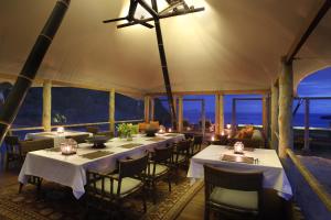 a dining room with tables and chairs in a tent at Jeeva Beloam Beach Camp in Tanjung Ringgit +37 photos
