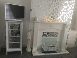 a toy room with a fireplace and a tv at Anfield heart of Liverpool in Liverpool