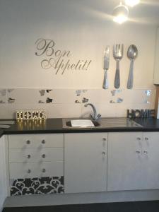 a kitchen with a black counter top and silver utensils at Anfield heart of Liverpool in Liverpool
