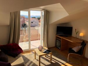 a living room with a view of a large window at Viktoria Lodge Bed and Breakfast in Vodice