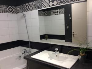 a bathroom with a sink and a tub and a mirror at La Terrasse La Tremblade in La Tremblade +39 photos