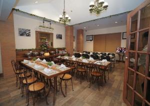 a restaurant with tables and chairs in a room at 1775 Adriatico Suites in Manila