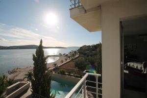 a view of the water from a balcony of a house at Apartments Marer in Trogir