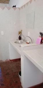 
a bathroom with a sink and a mirror at Pumahuasi Hostal Boutique in Purmamarca
