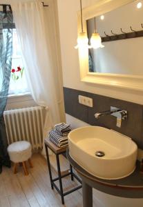 La salle de bains est pourvue d'un lavabo et d'un miroir. dans l'établissement Weinhotel Oechsle & Brix, à Sommerhausen