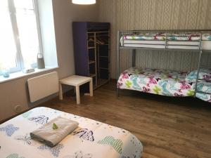 a room with two bunk beds and a table at Les Lilas Roses in Chamouilley