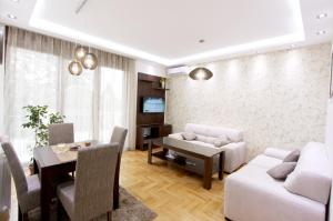 a living room with a table and a dining room at Apartment Iris in Belgrade