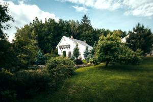 a white house in the middle of a yard at Pension U Sebastiana in Hodousice