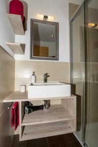 a bathroom with a sink and a glass shower at Chalet la cordée in Bettmeralp +19 photos