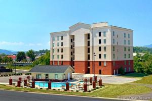 a large building with a house in front of it at River Crossing #405 in Pigeon Forge