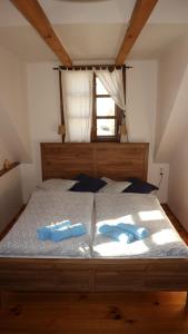 a bedroom with a bed with two blue shoes on it at penzion Drevenica in Šumiac +49 photos