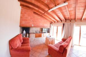 a living room with two chairs and a fireplace at Villa Putxet in Inca